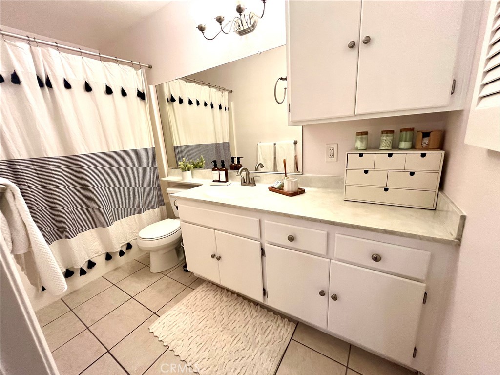 12635 Briarglen Loop, Unit K Stanton, CA 90680 - Photo 10 of 12 a spacious bathroom with double vanity two mirror a bathtub and a shower