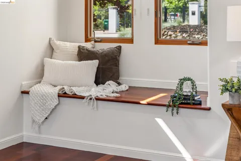 a living room with furniture a window and a painting on the wall