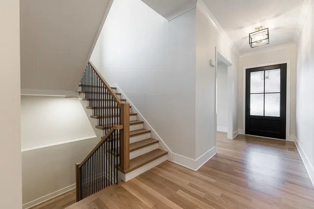 a view of a hallway with wooden floor and entryway