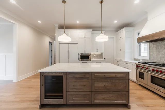 a kitchen with a stove and a wooden floor