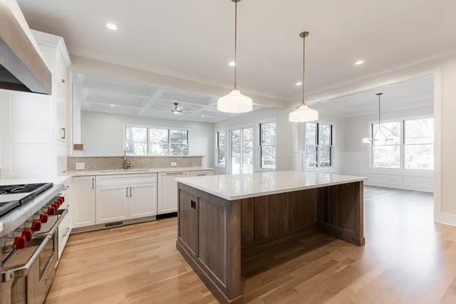 a kitchen with kitchen island a sink stainless steel appliances and cabinets