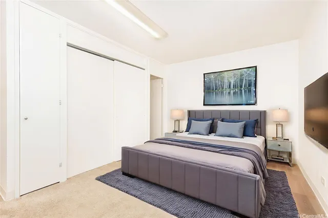 a bedroom with a bed and a flat screen tv