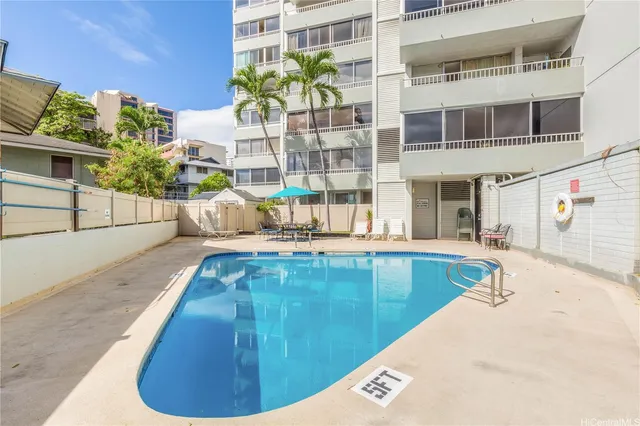 a view of a swimming pool with a lounge chairs