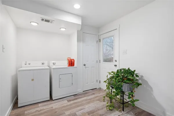 a utility room with cabinets washer and dryer