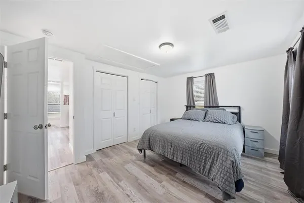 a bedroom with a bed and a closet