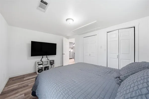 a bedroom with a bed and a flat screen tv