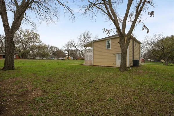 a view of a backyard with large trees