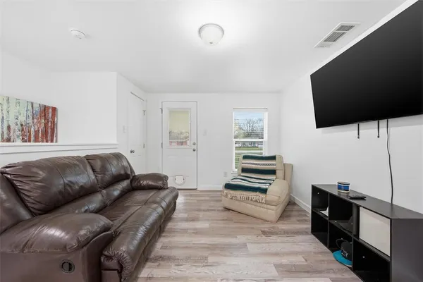 a bedroom with furniture and a flat screen tv