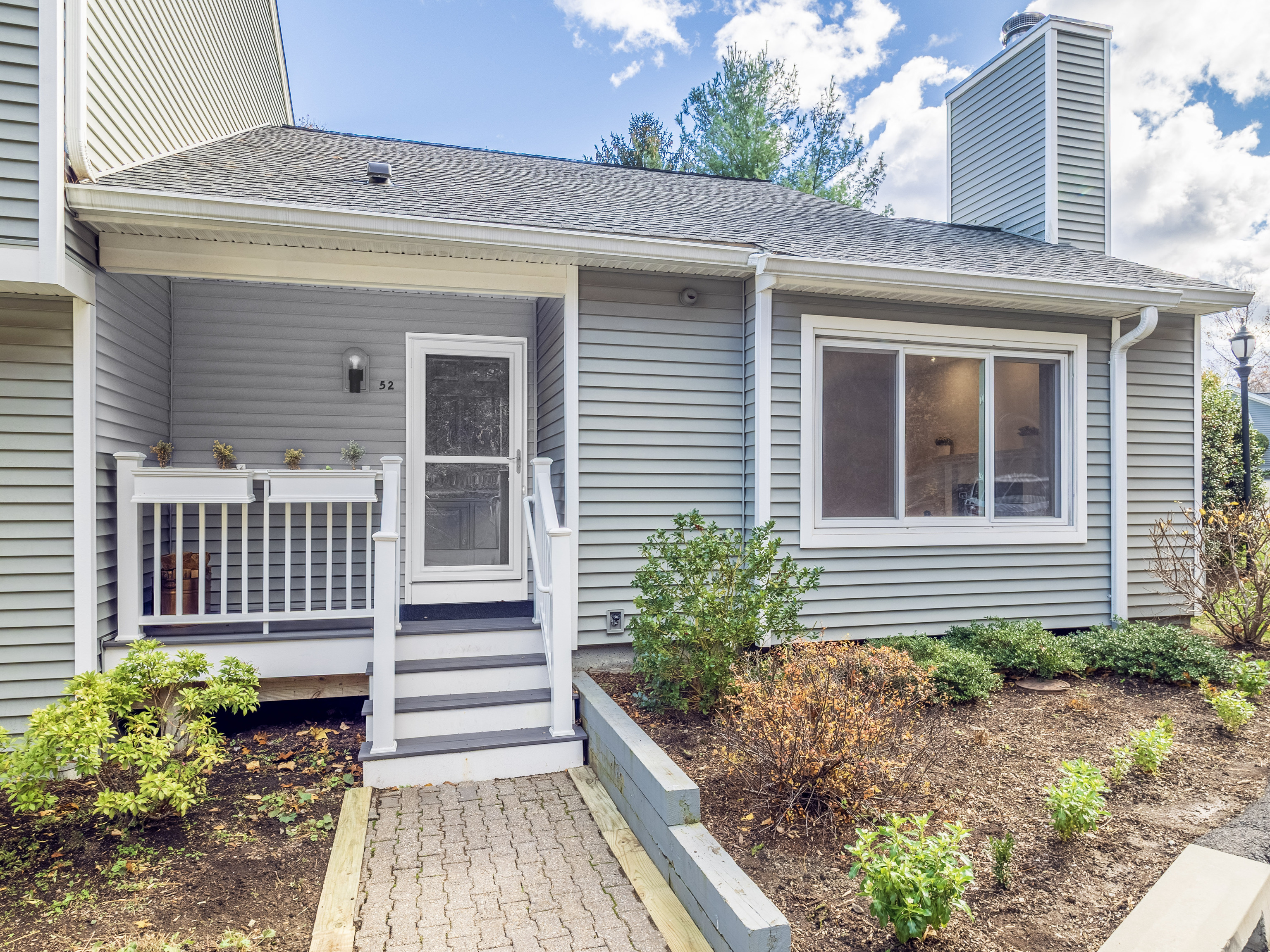 a front view of a house with a garden