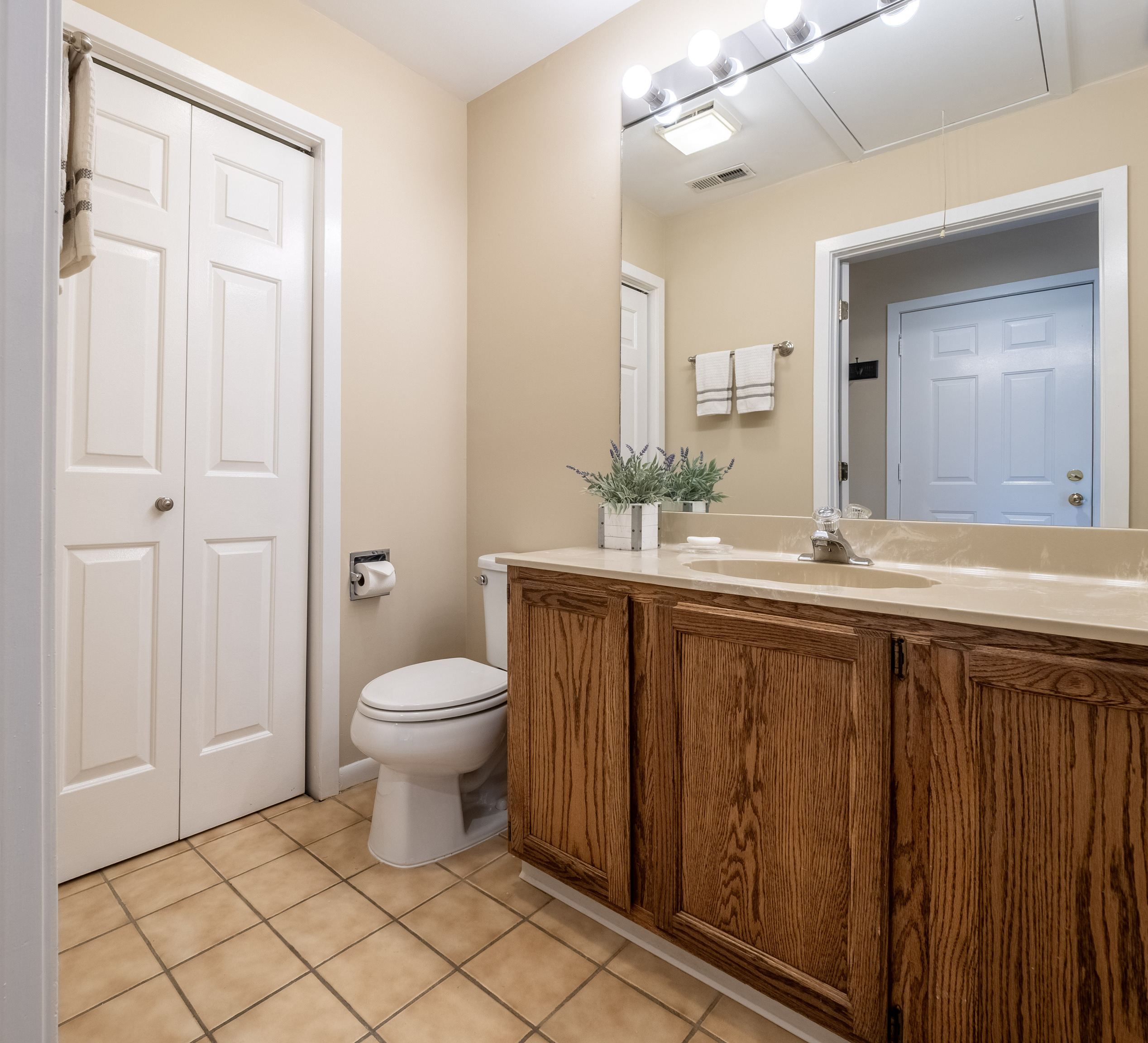 52 Glen Ridge, Unit 52 Wilton, CT 06897 - Photo 10 of 27 a bathroom with a granite countertop sink toilet and mirror