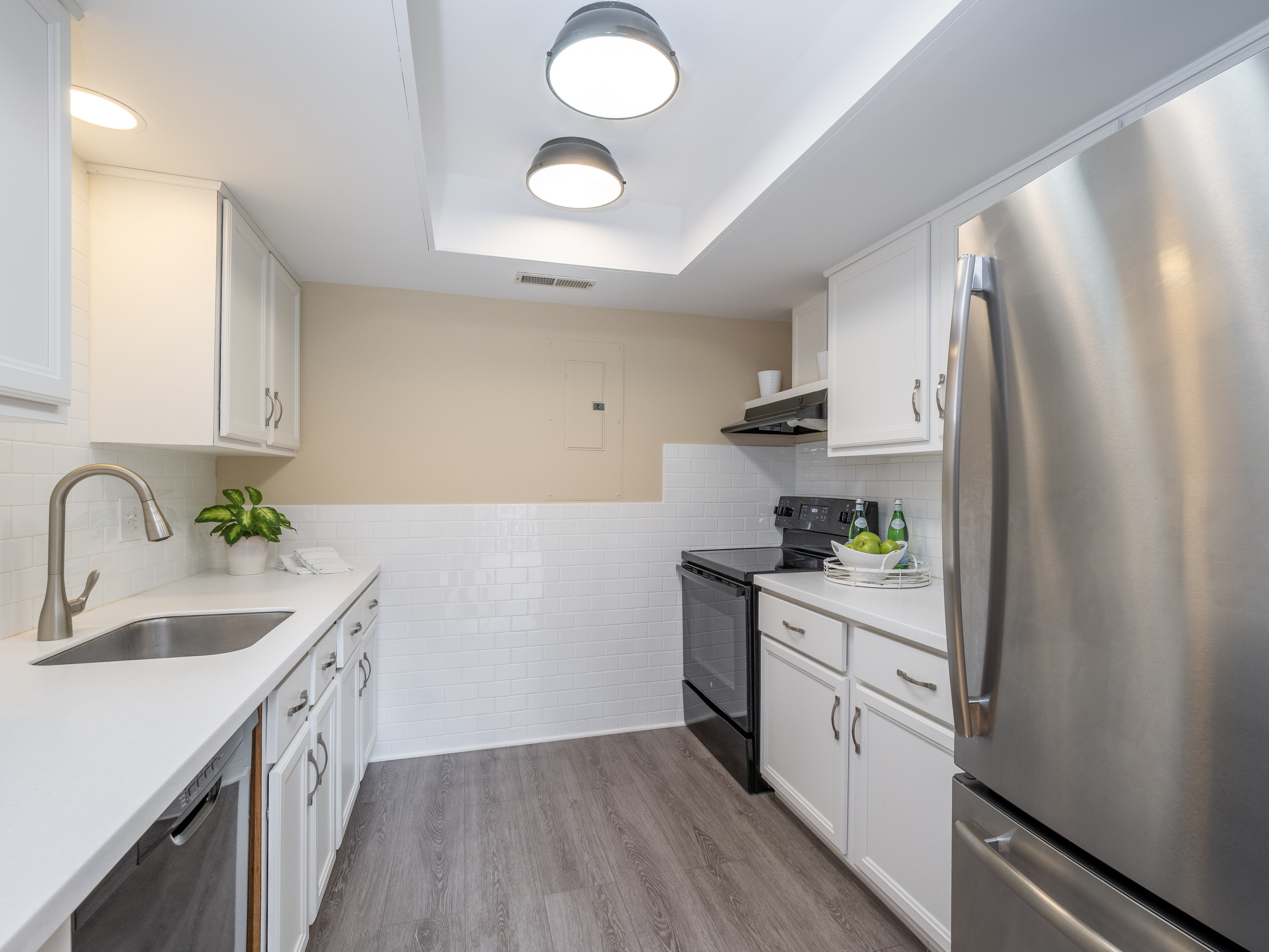 52 Glen Ridge, Unit 52 Wilton, CT 06897 - Photo 12 of 27 a kitchen with a sink a counter top space stainless steel appliances and cabinets