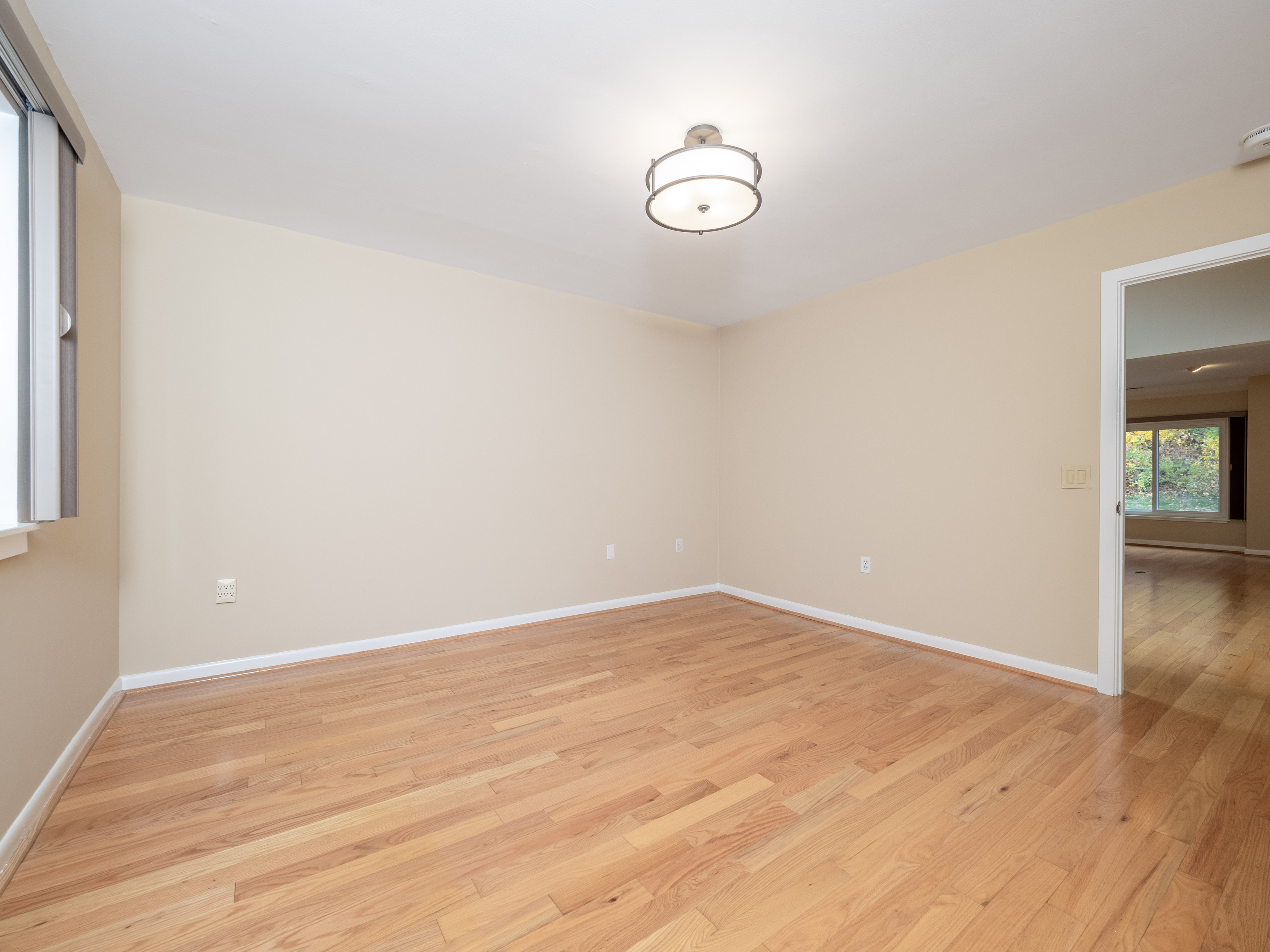 52 Glen Ridge, Unit 52 Wilton, CT 06897 - Photo 15 of 27 an empty room with wooden floor and windows