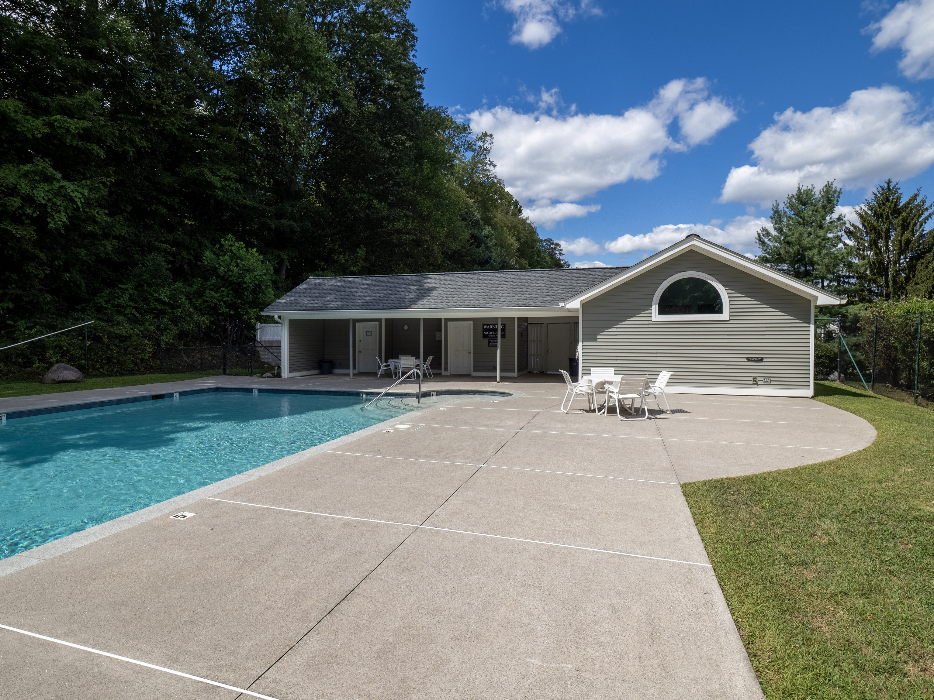 52 Glen Ridge, Unit 52 Wilton, CT 06897 - Photo 21 of 27 a front view of house with yard and green space