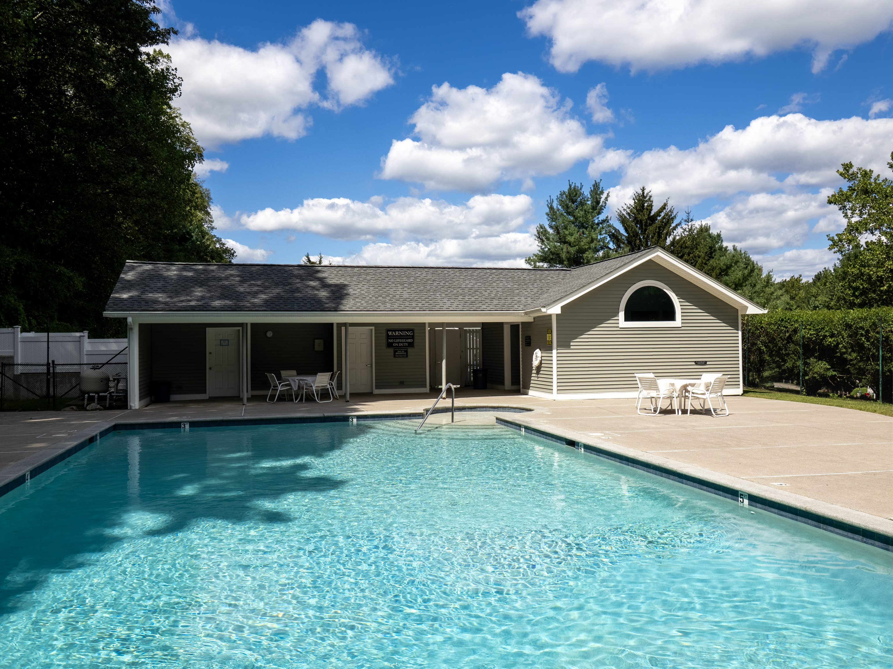 52 Glen Ridge, Unit 52 Wilton, CT 06897 - Photo 22 of 27 a front view of house with yard barbeque and outdoor seating