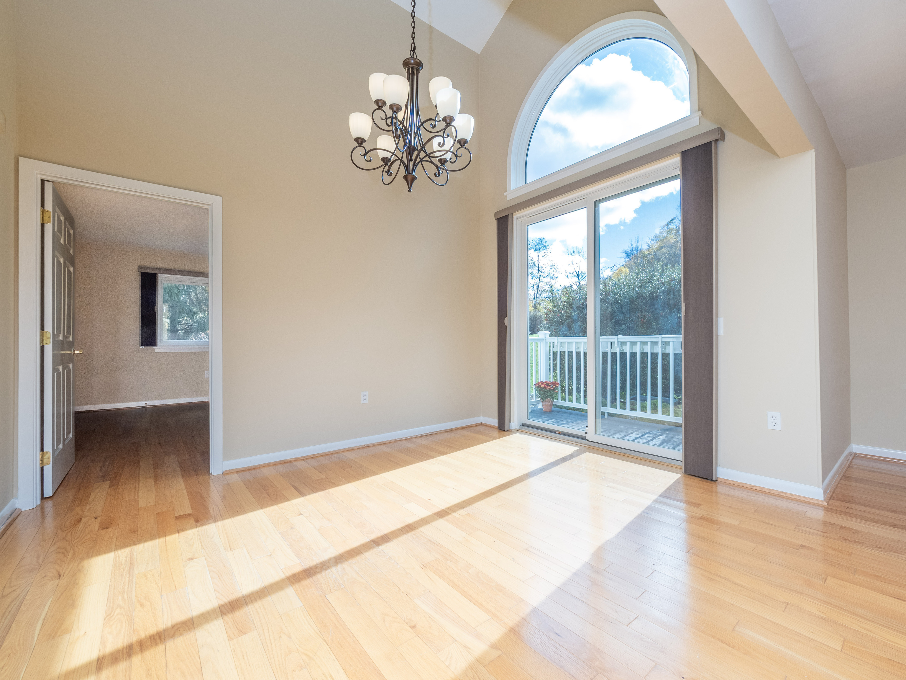 52 Glen Ridge, Unit 52 Wilton, CT 06897 - Photo 8 of 27 a view of a livingroom with a chandelier curtains and wooden floor