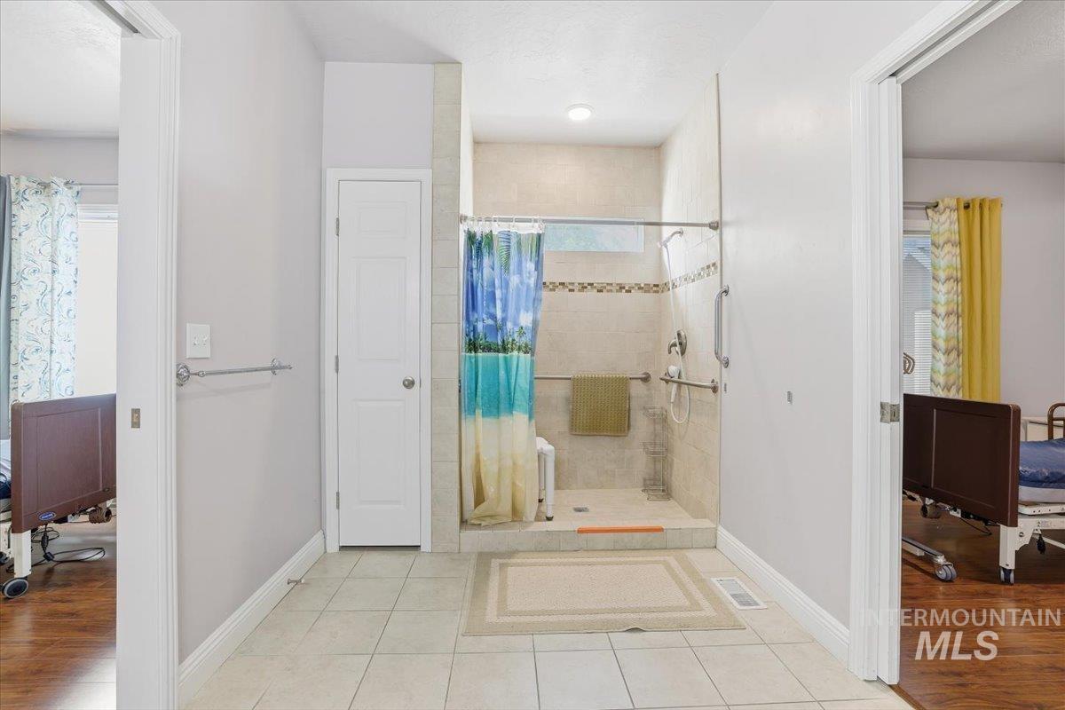7501 West Swift Lane Boise, ID 83704 - Photo 30 of 50 Full bath with a walk in shower and light tile patterned floors