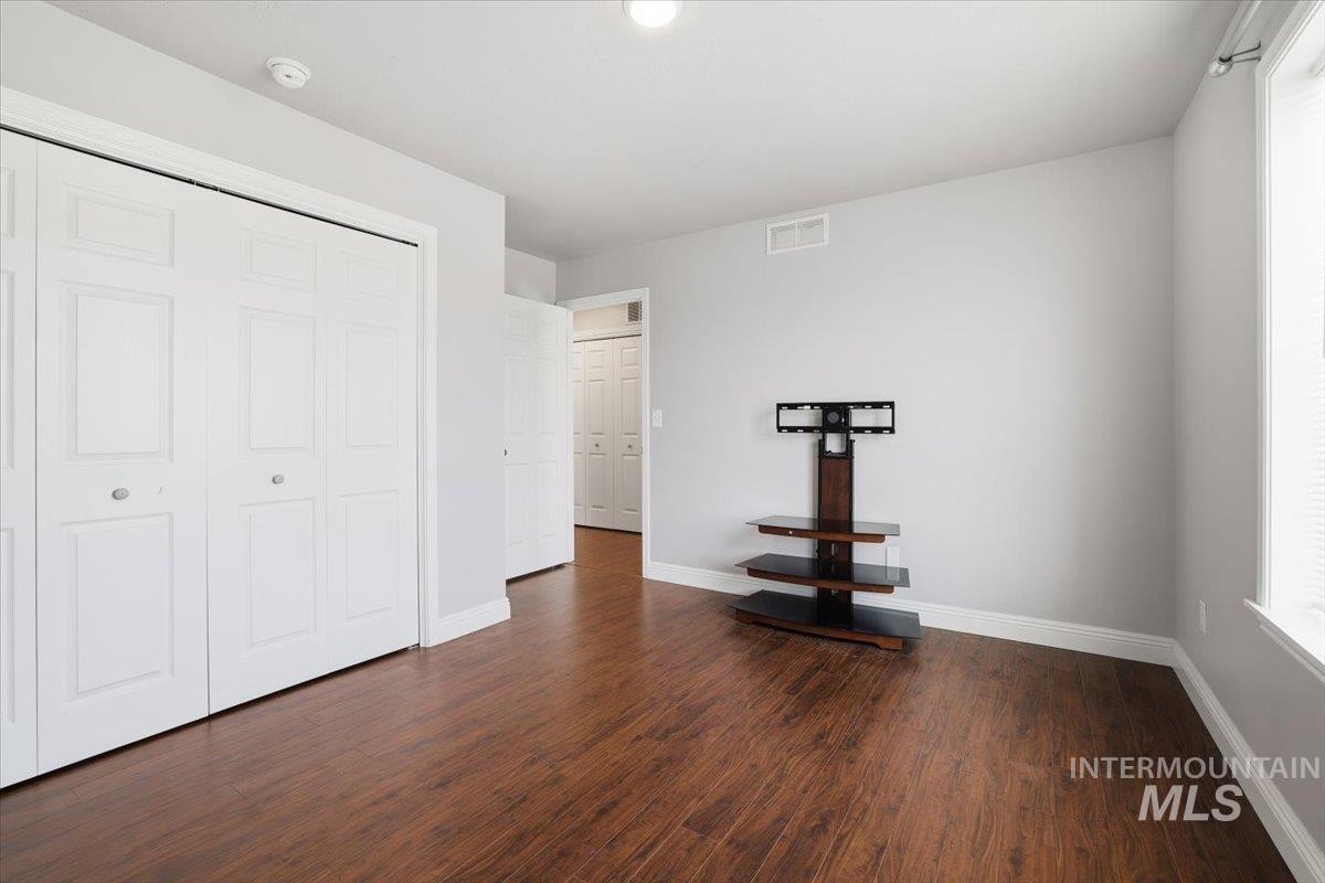 7501 West Swift Lane Boise, ID 83704 - Photo 36 of 50 Unfurnished bedroom featuring dark wood finished floors and a closet