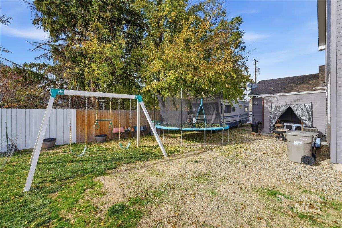 7501 West Swift Lane Boise, ID 83704 - Photo 49 of 50 Fenced backyard featuring a playground and a trampoline