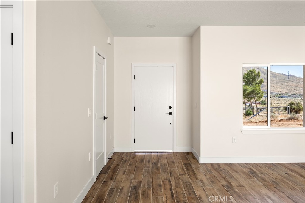 22324 Rancho Street Apple Valley, CA 92308 - Photo 11 of 47 a view of a room with wooden floor and windows