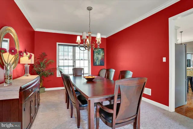 a view of a dining room with furniture and a chandelier