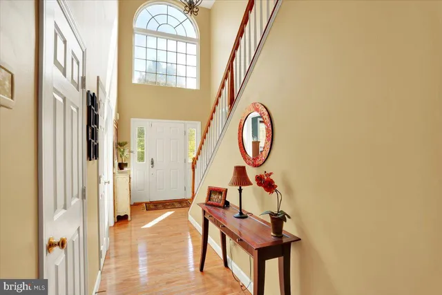 a view of a hallway with entryway wooden floor and front door