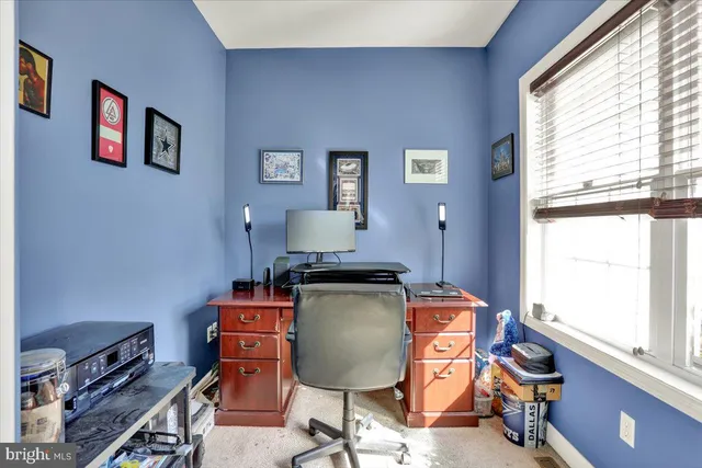 a view of a livingroom with wooden floor and furniture
