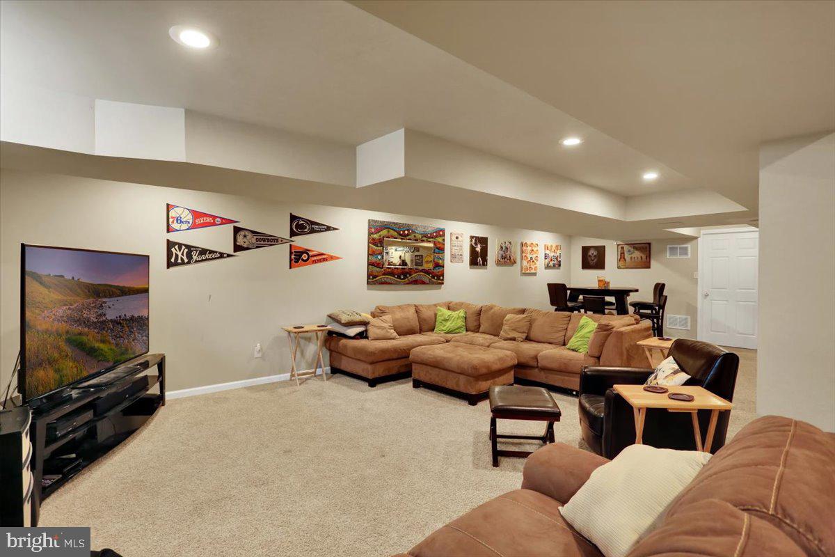 21 Sawgrass Drive Reading, PA 19606 - Photo 26 of 51 a living room with furniture and a flat screen tv