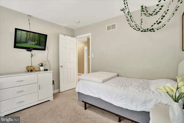 a bedroom with a bed and a night stand