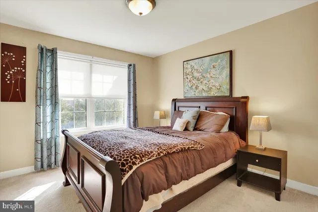 a large bed sitting in a bedroom next to a lamp