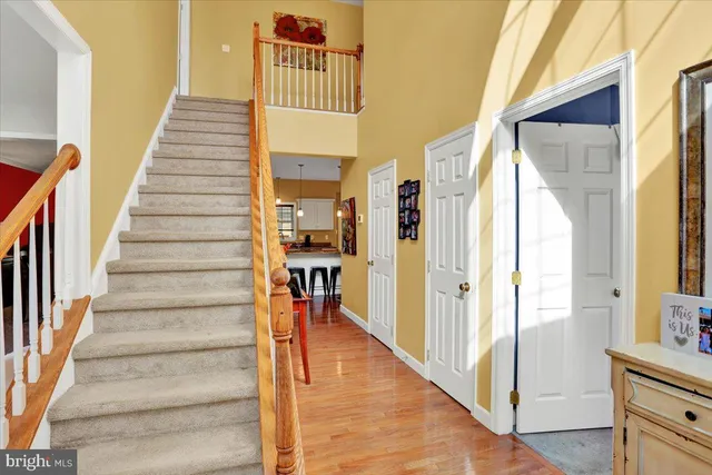 a view of entryway and hall with wooden floor