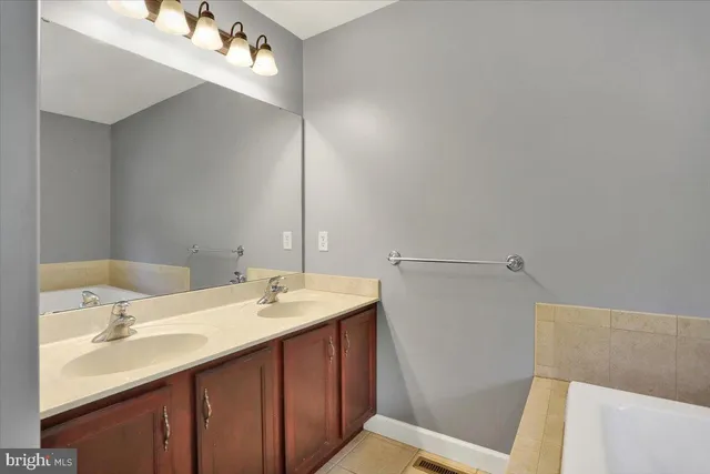 a bathroom with a sink and mirror