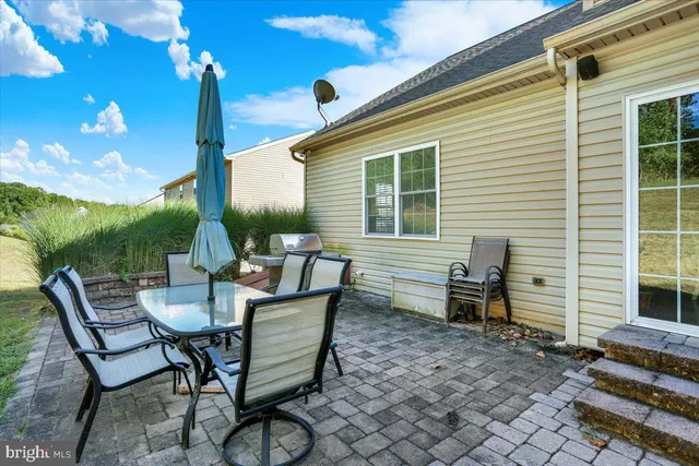 a view of a patio with table and chairs and potted plants