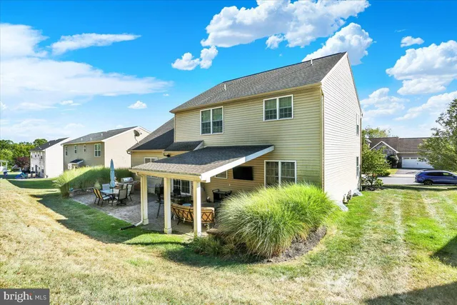 a view of a house with backyard porch and sitting area