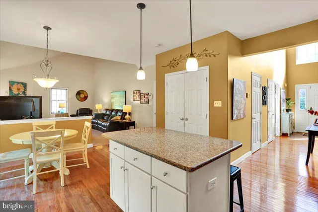 a large kitchen with a table and chairs