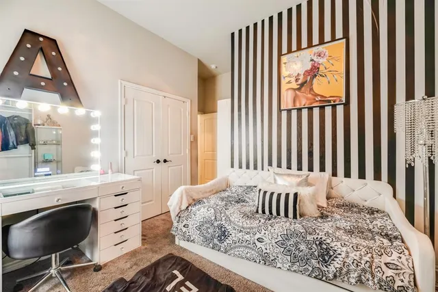 a view of a bedroom with furniture and window