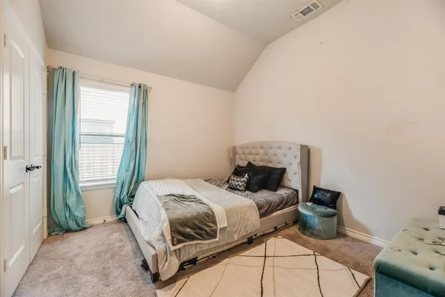 a bedroom with a bed and window