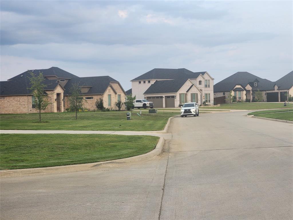 124 Chisolm Trail Pottsboro, TX 75076 - Photo 14 of 15 View of concrete street with curbs and a residential view