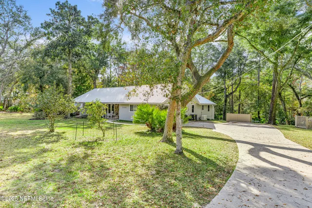 a living room with furniture a rug and a window