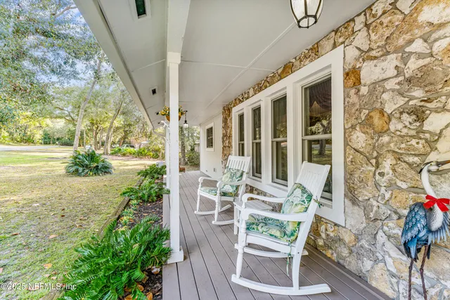 a living room with furniture a rug and a chandelier
