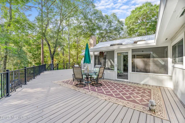 a kitchen with granite countertop a sink dishwasher a stove and white cabinets with wooden floor