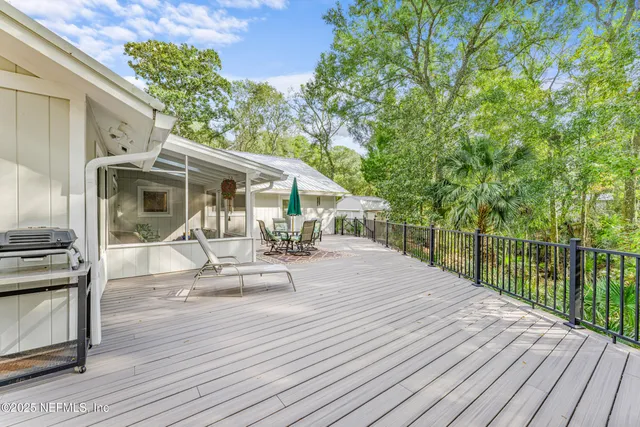 a bedroom with a bed and a dresser with wooden floor