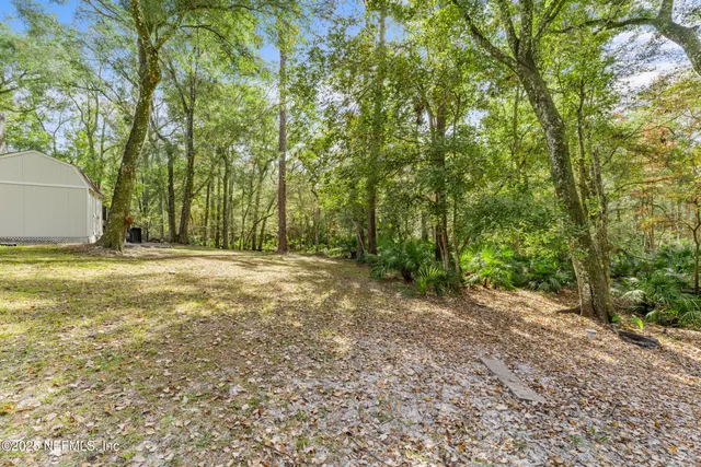 a living room with furniture wooden floor and a table