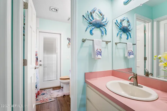 an aerial view of residential houses with outdoor space and trees