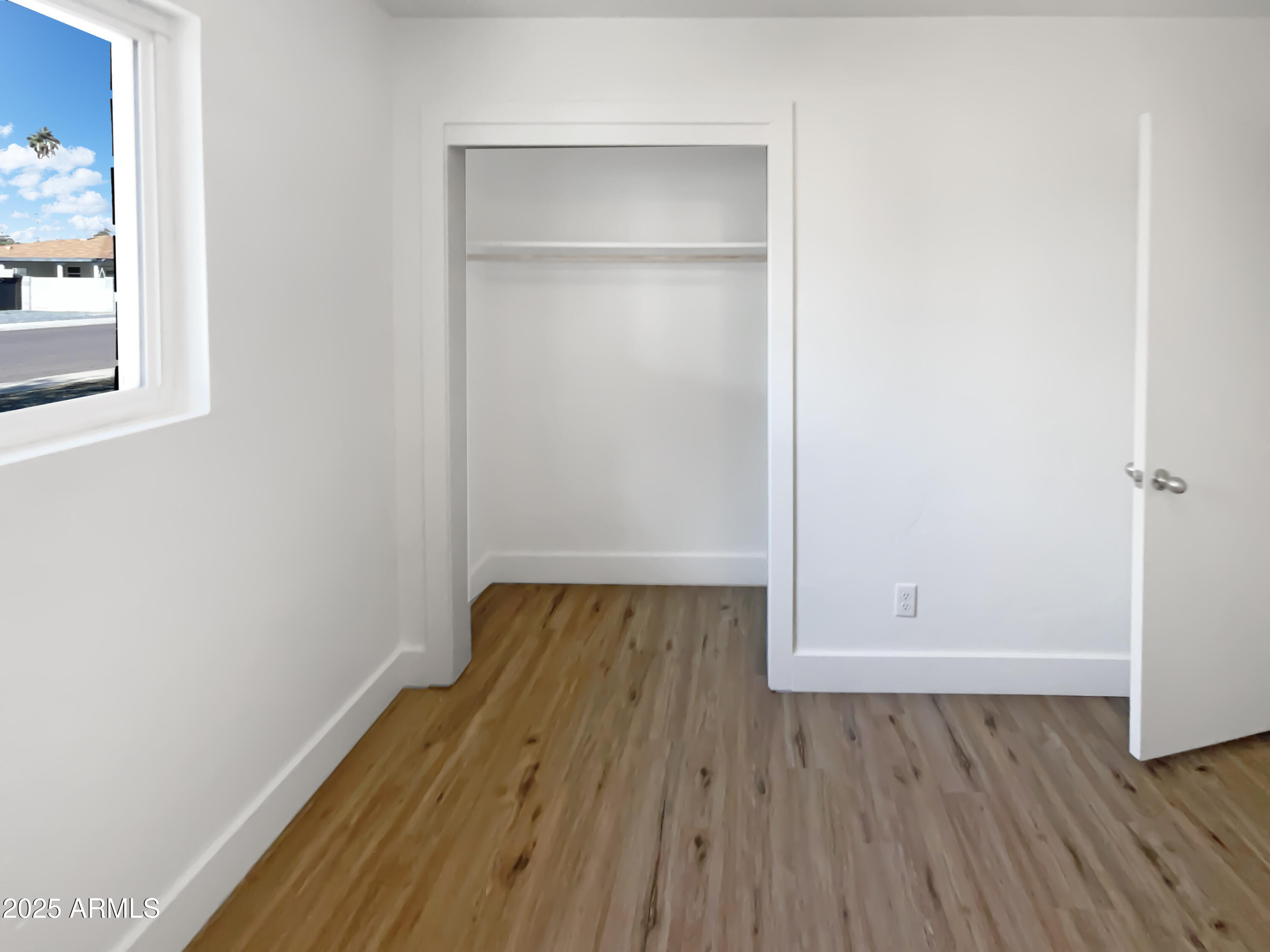 7231 North 23rd Avenue Phoenix, AZ 85021 - Photo 24 of 28 an empty room with wooden floor and closet