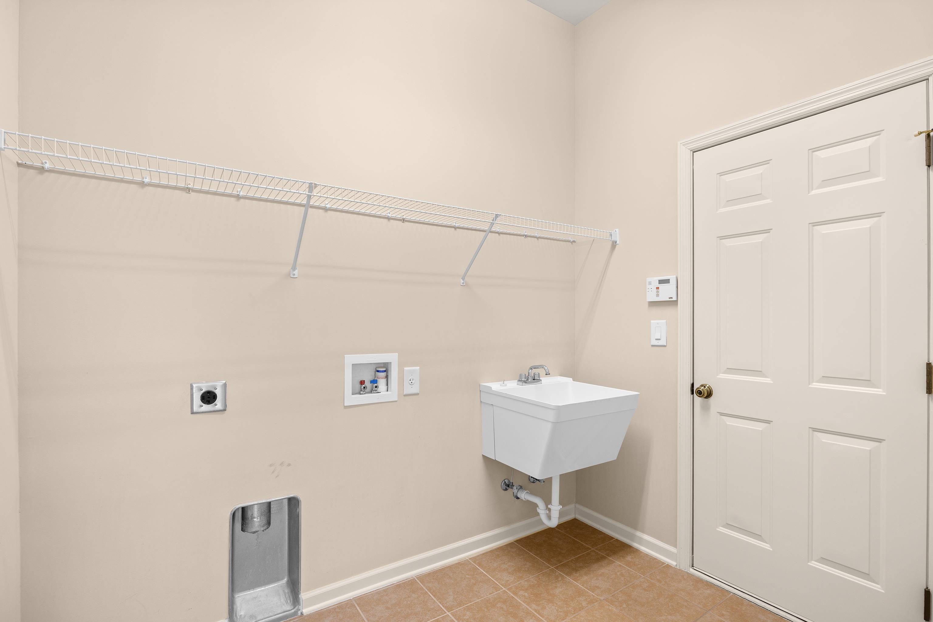 1006 Nittany Court Murrells Inlet, SC 29576 - Photo 23 of 39 Washer / Dryer hook up, utility sink, and a large storage closet. The door is access to the 2-car garage.