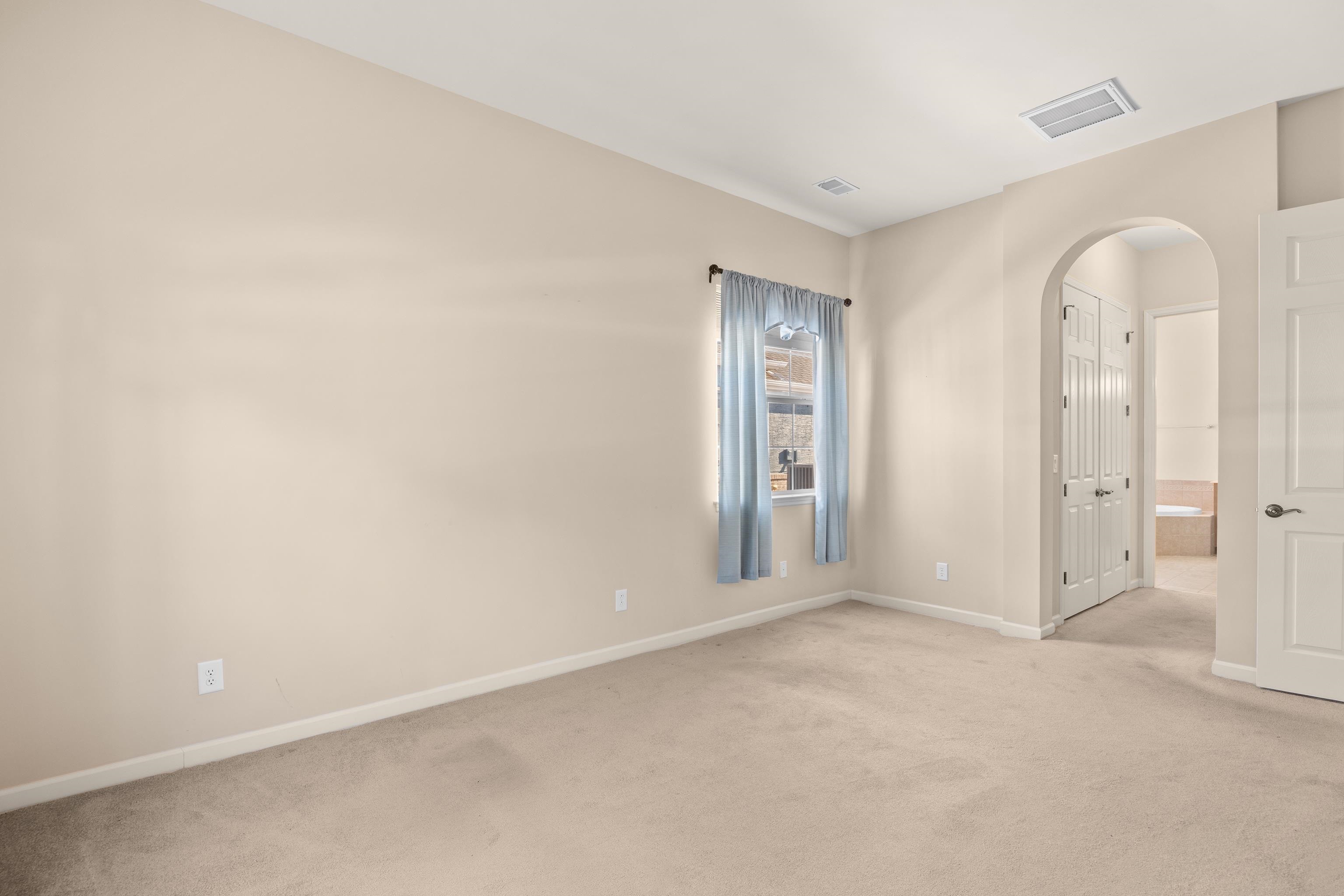 1006 Nittany Court Murrells Inlet, SC 29576 - Photo 25 of 39 Picture shows room without ant virtually staged furniture. Arched doorway leads to two walk-in closets and bathroom.