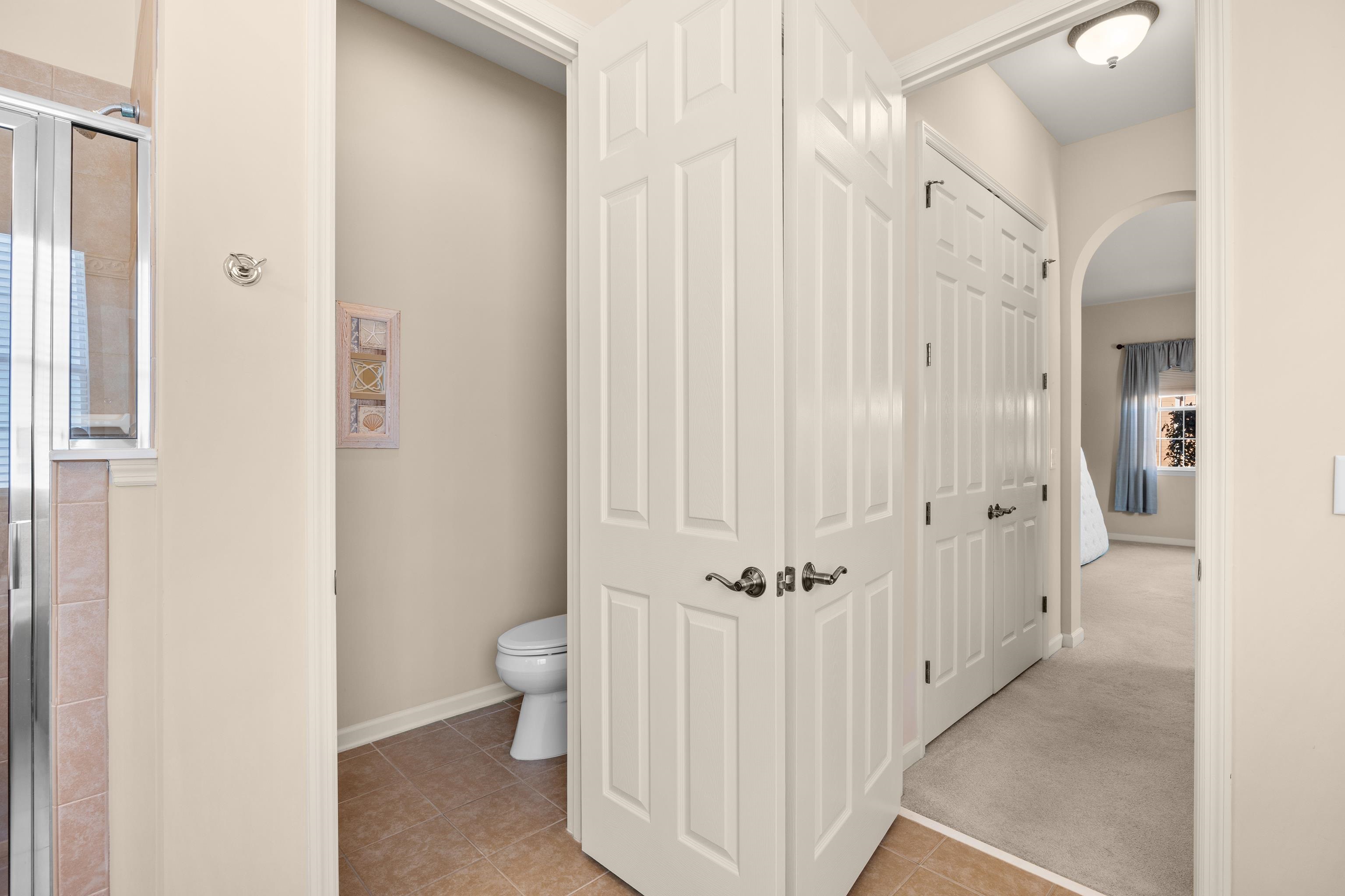 1006 Nittany Court Murrells Inlet, SC 29576 - Photo 29 of 39 Door opened to the left is the private water closet, door open to the right is the hallway to the two closets.