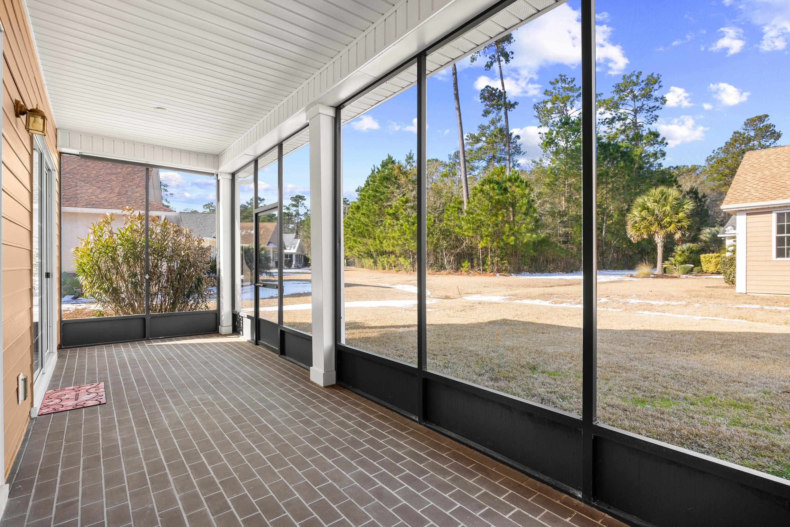 1006 Nittany Court Murrells Inlet, SC 29576 - Photo 36 of 39 The porch floor has been finished with brick pavers to match the front porch and front walkway.