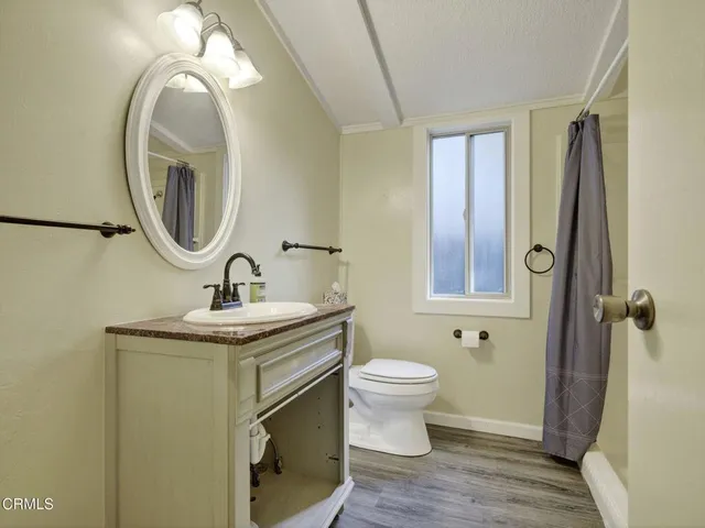 a bathroom with a toilet a sink and a mirror