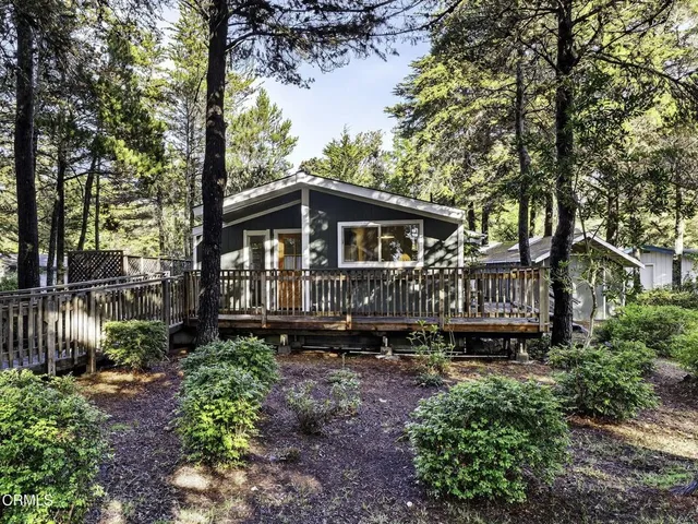 a view of a house with yard and sitting area
